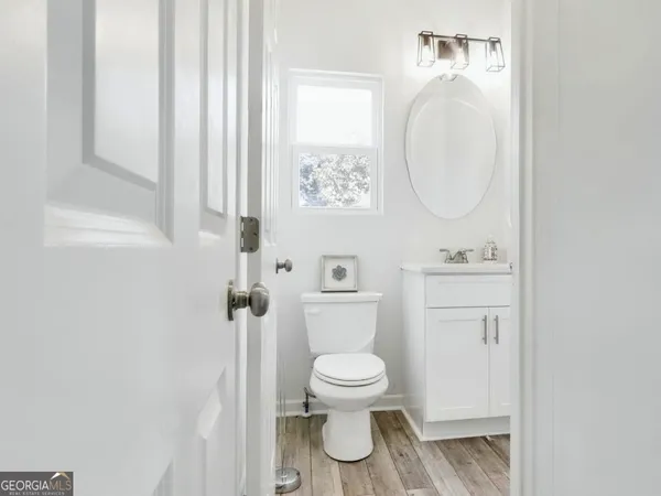 a white toilet sitting next to a bathroom sink