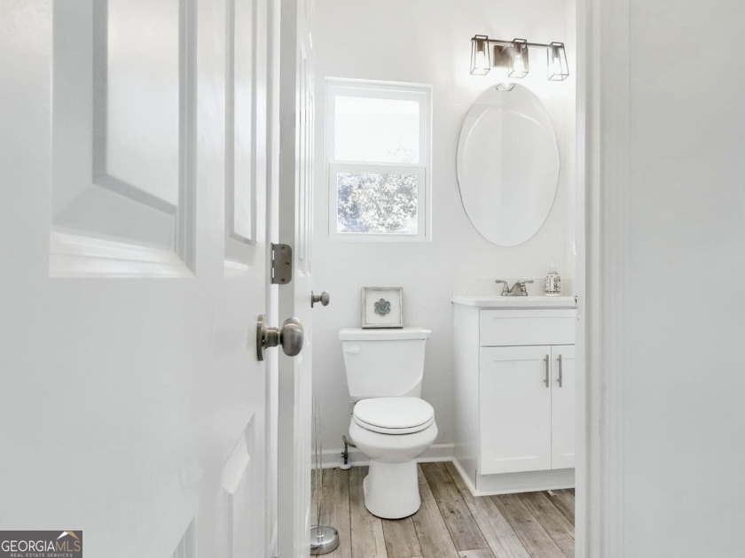157 Pinto Lane Fairmount, GA 30139 - Photo 8 of 19 a white toilet sitting next to a bathroom sink