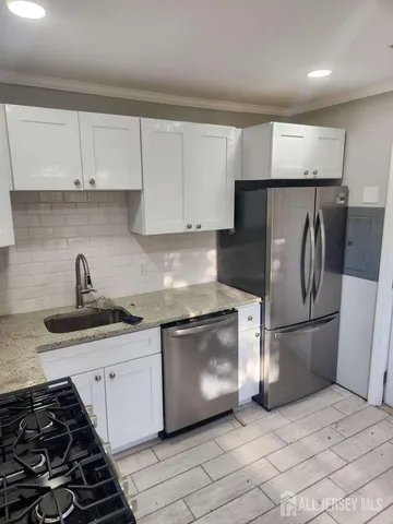 a kitchen with a sink and a stove top oven