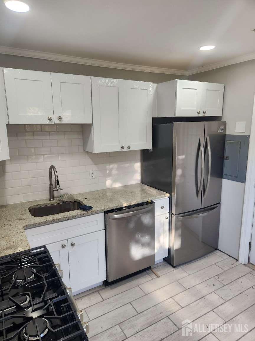 223 Plainfield Avenue Edison, NJ 08817 - Photo 2 of 6 a kitchen with a sink and a stove top oven