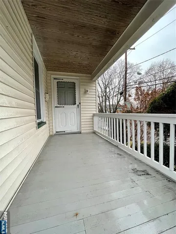 a view of a house with porch and wooden floor