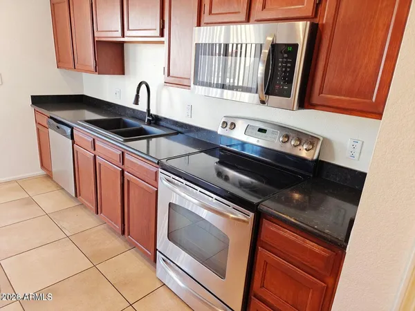 a kitchen with a sink stove and cabinets