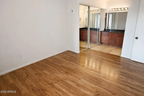 a view of a kitchen with refrigerator and wooden floor