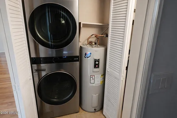 a close view of a utility room with dryer and washer