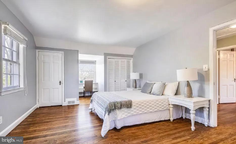 5806 Kenmore Road Baltimore, MD 21210 - Photo 16 of 35 a bedroom with a bed and wooden floor