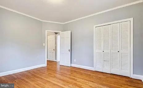 5806 Kenmore Road Baltimore, MD 21210 - Photo 21 of 35 a view of an empty room with wooden floor and a window