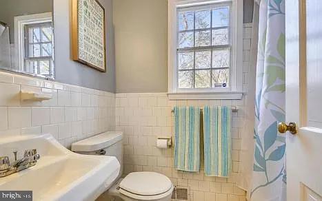 5806 Kenmore Road Baltimore, MD 21210 - Photo 24 of 35 a white toilet sitting next to a bathroom sink