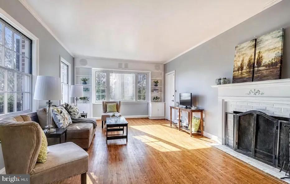 5806 Kenmore Road Baltimore, MD 21210 - Photo 7 of 35 a living room with furniture large window and a fireplace