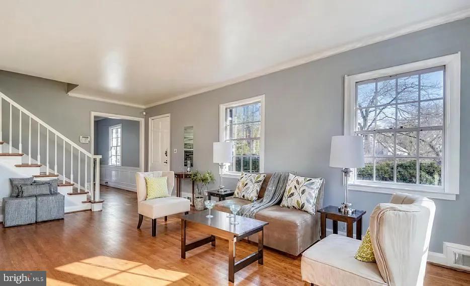 5806 Kenmore Road Baltimore, MD 21210 - Photo 8 of 35 a living room with furniture wooden floor and a large window