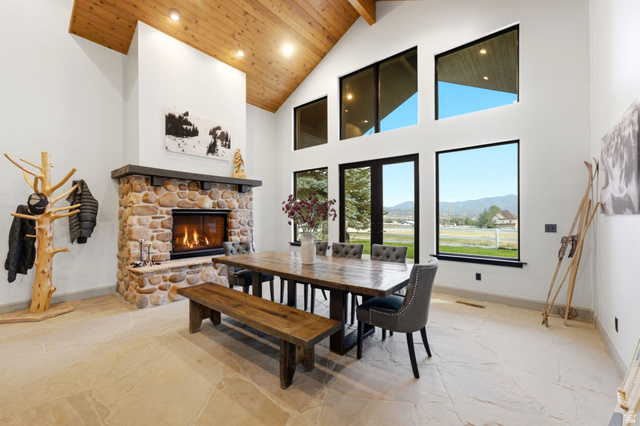 8650 Redden Road Park City, UT 84098 - Photo 5 of 71 Vaulted wood-finish ceiling, stone fireplace with hearth, multiple large windows, and light-toned tile flooring