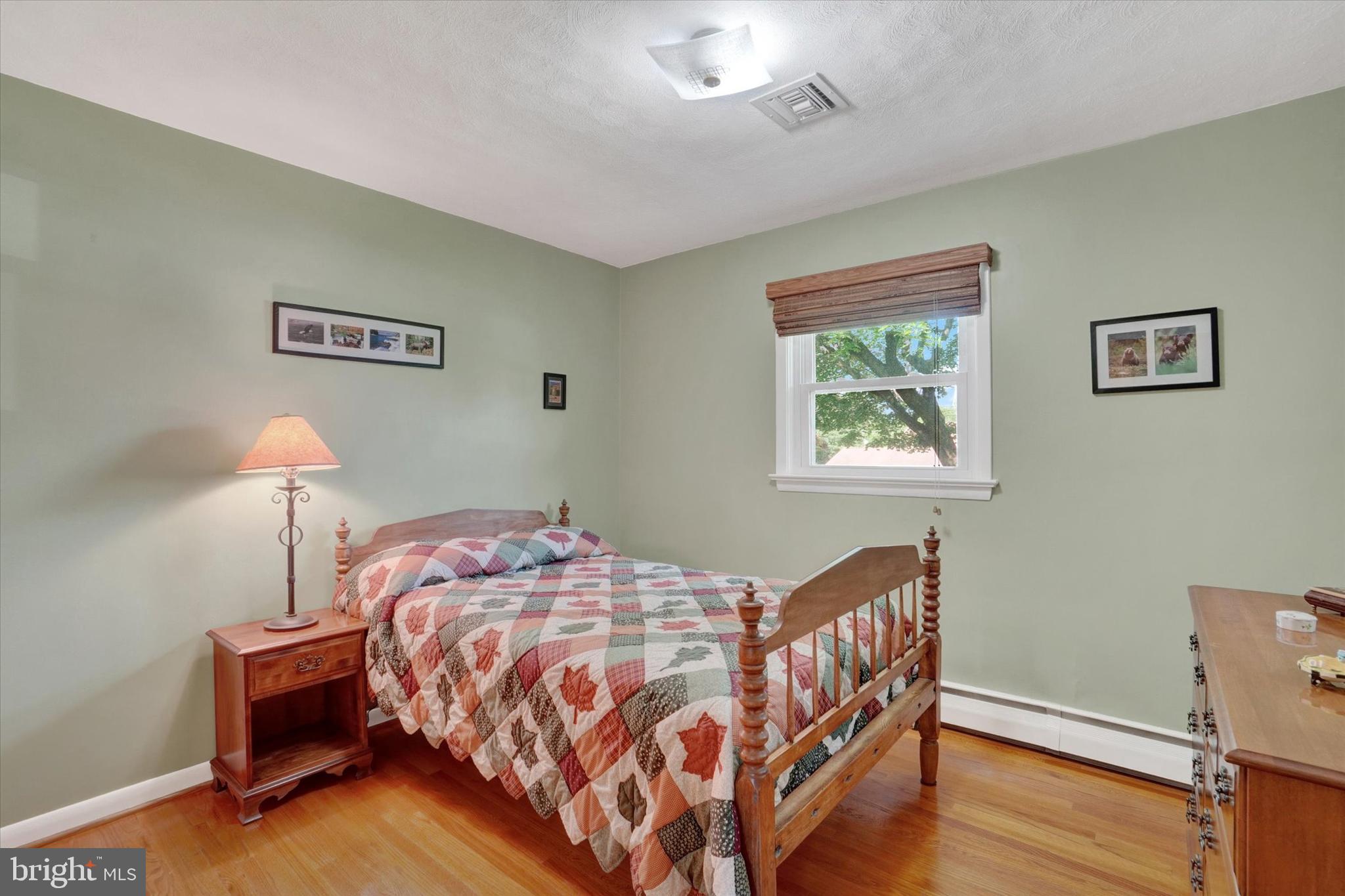 2320 Sycamore Road York, PA 17408 - Photo 15 of 26 a bedroom with a bed and a lamp on table