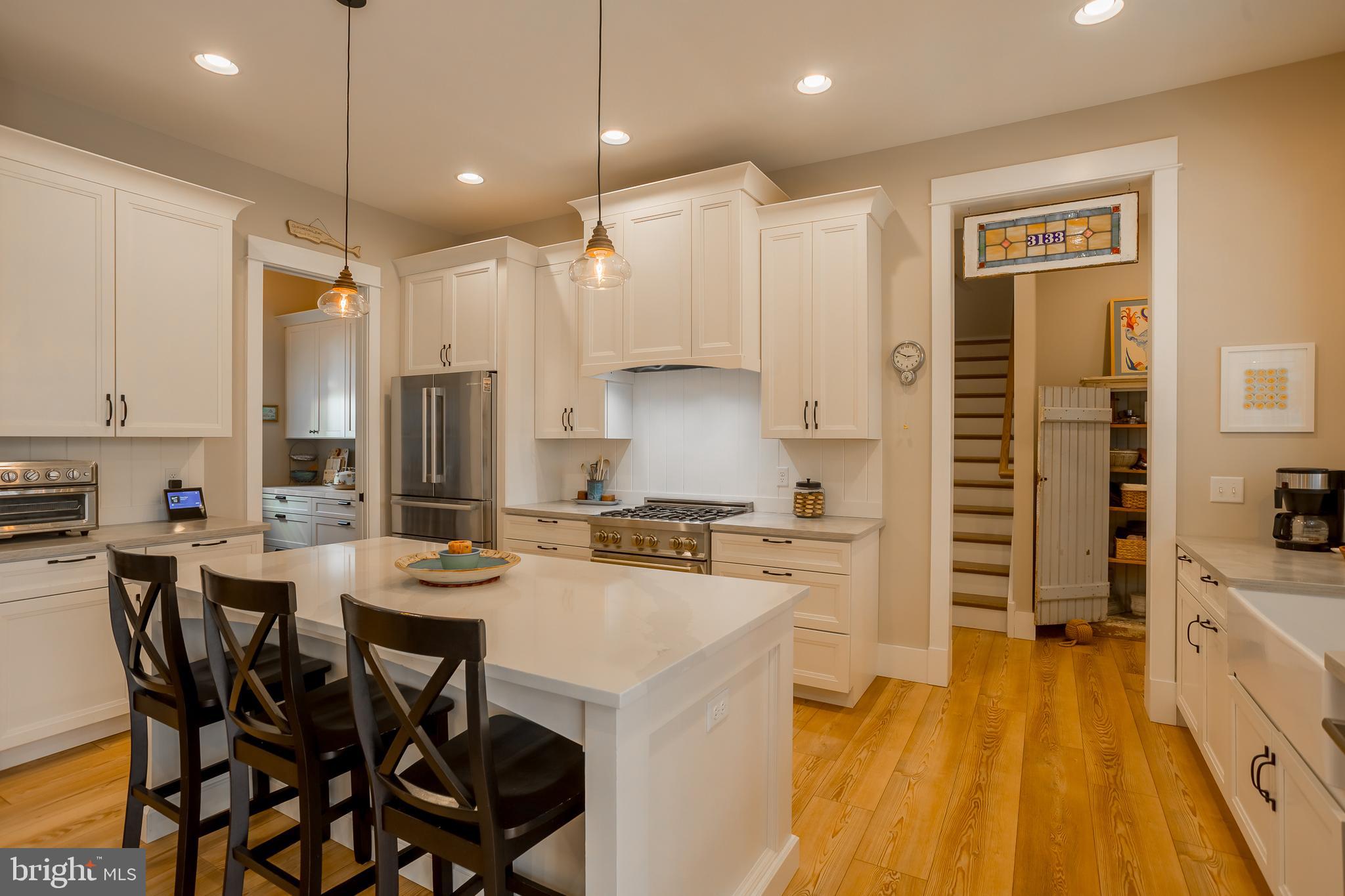 10 Haven Drive Georgetown, DE 19947 - Photo 24 of 76 a kitchen with stainless steel appliances a stove a sink a oven a dining table and chairs