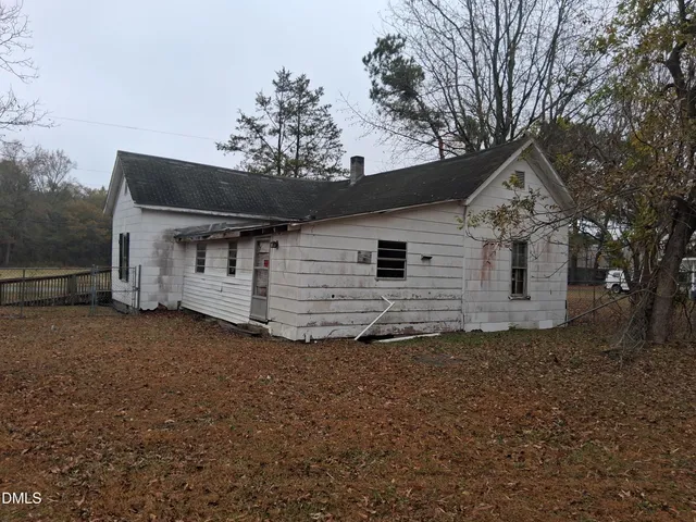 a view of a house with a large tree and a big yard
