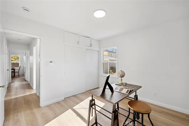 a view of a room with a table and chairs