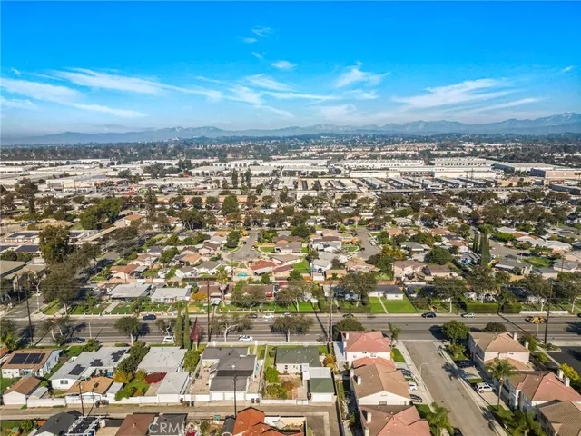 a view of a house with a yard and potted plants
