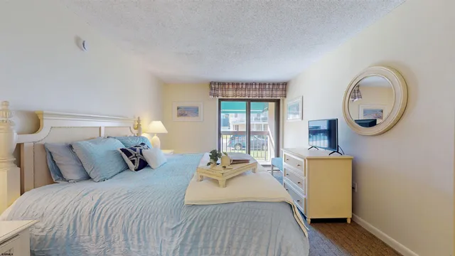 a bedroom with bed and a dresser