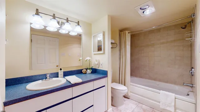 a bathroom with a sink a toilet and a large mirror