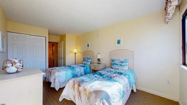 a bedroom with two beds and a window