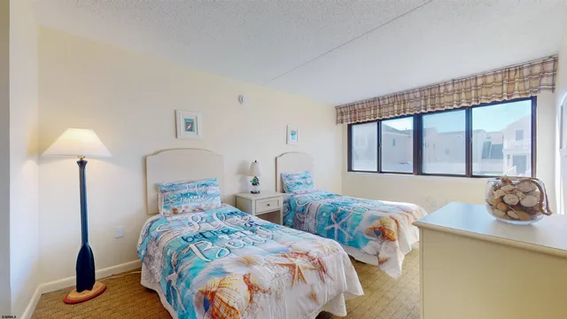 a bedroom with two beds and a window