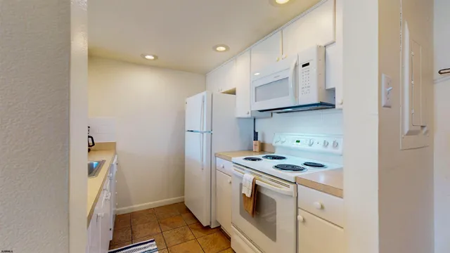 a kitchen with stainless steel appliances granite countertop a stove and a refrigerator