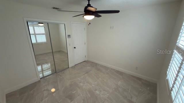 633 Spring Oaks Boulevard Altamonte Springs, FL 32714 - Photo 24 of 37 en empty room with windows and ceiling fan
