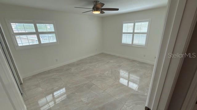 633 Spring Oaks Boulevard Altamonte Springs, FL 32714 - Photo 25 of 37 an empty room with windows and fan