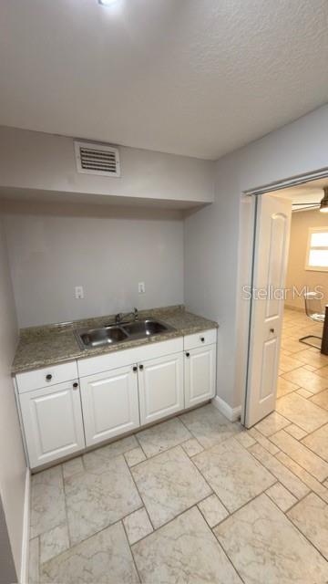 633 Spring Oaks Boulevard Altamonte Springs, FL 32714 - Photo 32 of 37 a kitchen with granite countertop cabinets and white appliances