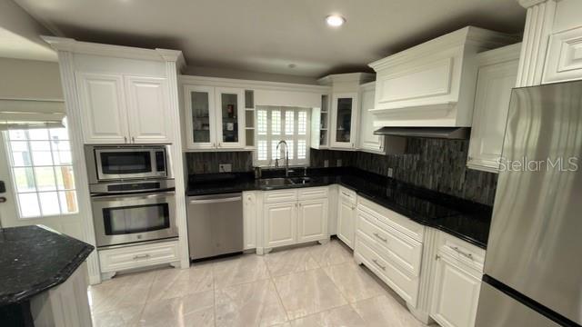633 Spring Oaks Boulevard Altamonte Springs, FL 32714 - Photo 9 of 37 a kitchen with a refrigerator and a stove top oven