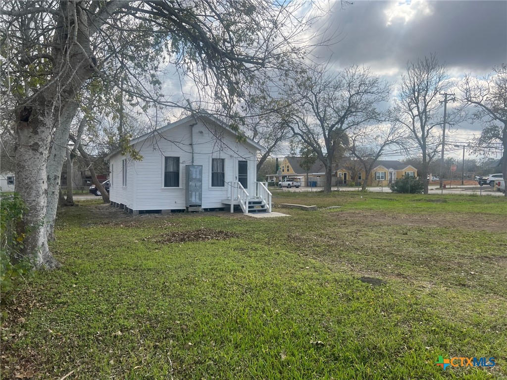 327 West Main Street Port Lavaca, TX 77979 - Photo 3 of 11 a front view of house with yard and trees