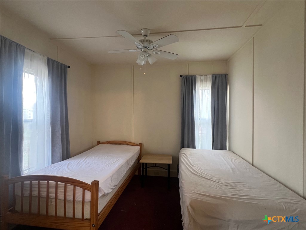 327 West Main Street Port Lavaca, TX 77979 - Photo 5 of 11 a bedroom with a bed and a chandelier