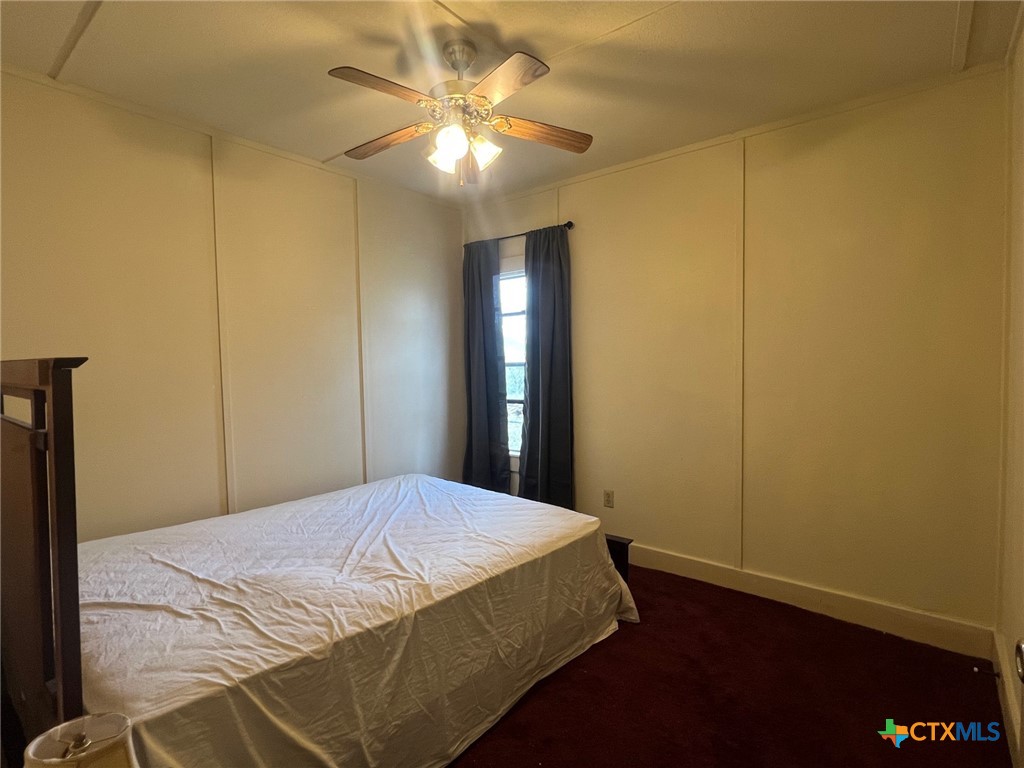 327 West Main Street Port Lavaca, TX 77979 - Photo 6 of 11 a bedroom with a bed and a chandelier
