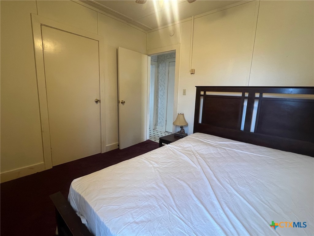 327 West Main Street Port Lavaca, TX 77979 - Photo 7 of 11 a bedroom with a bed and wooden floor