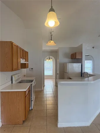 a living room with a sink furniture and a chandelier