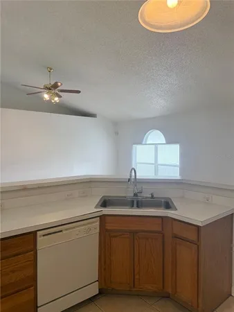 a kitchen with a sink cabinets and a stove