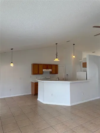 a large kitchen with kitchen island a sink stainless steel appliances and cabinets