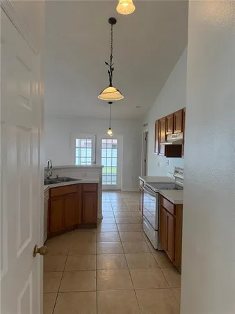 a kitchen with stainless steel appliances granite countertop a stove a sink dishwasher and a refrigerator