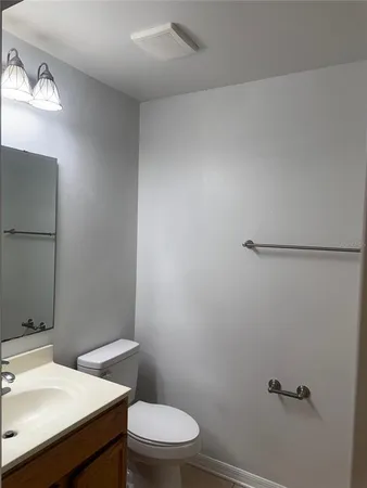 a white toilet sitting next to a bathroom sink