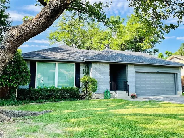 a view of a house with a yard and plants