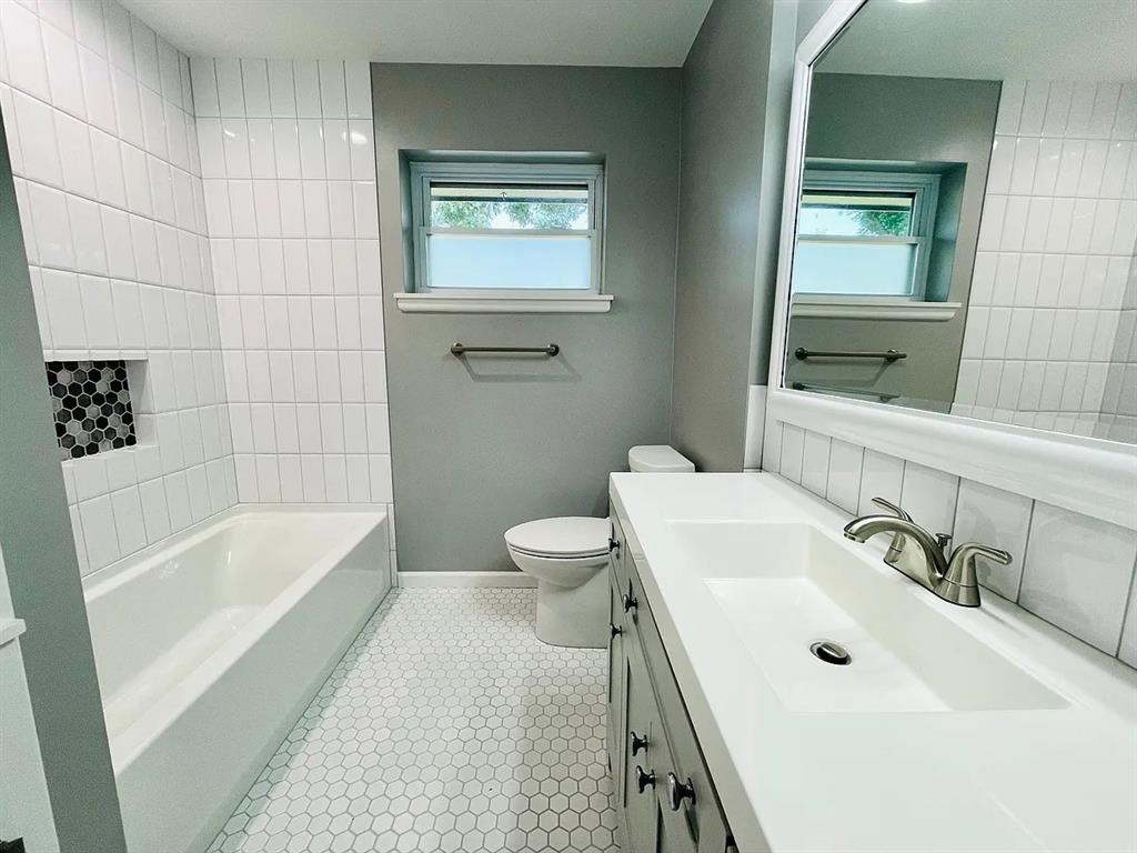 3152 Walnut Hill Lane Dallas, TX 75229 - Photo 11 of 18 a bathroom with a sink a toilet and shower