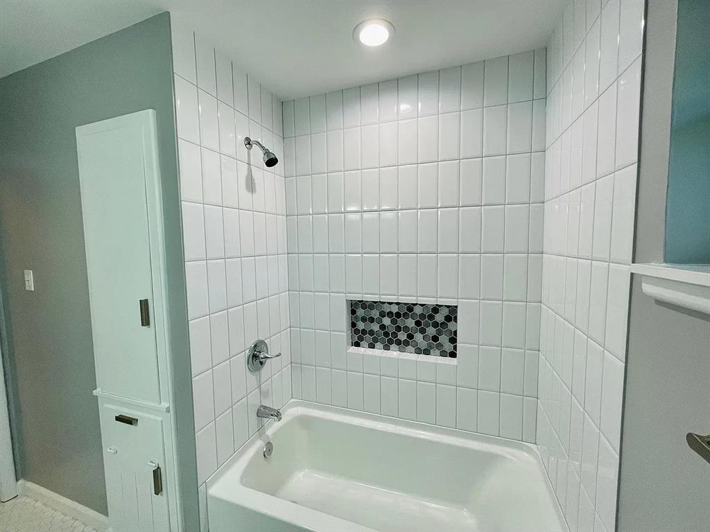 3152 Walnut Hill Lane Dallas, TX 75229 - Photo 12 of 18 a bathroom with a bathtub and shower