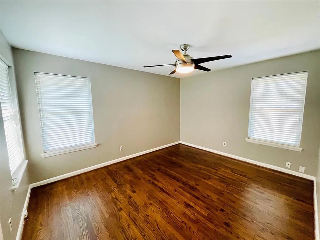 3152 Walnut Hill Lane Dallas, TX 75229 - Photo 13 of 18 a view of a room with wooden floor and a ceiling fan