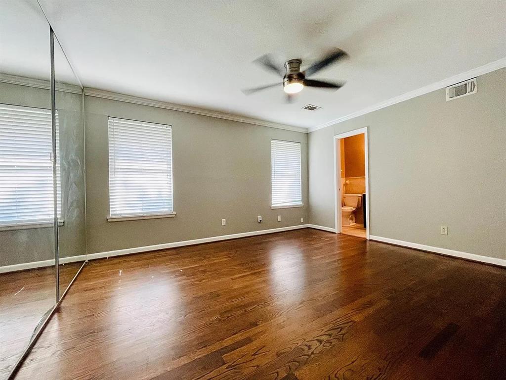 3152 Walnut Hill Lane Dallas, TX 75229 - Photo 14 of 18 a view of an empty room with window and wooden floor