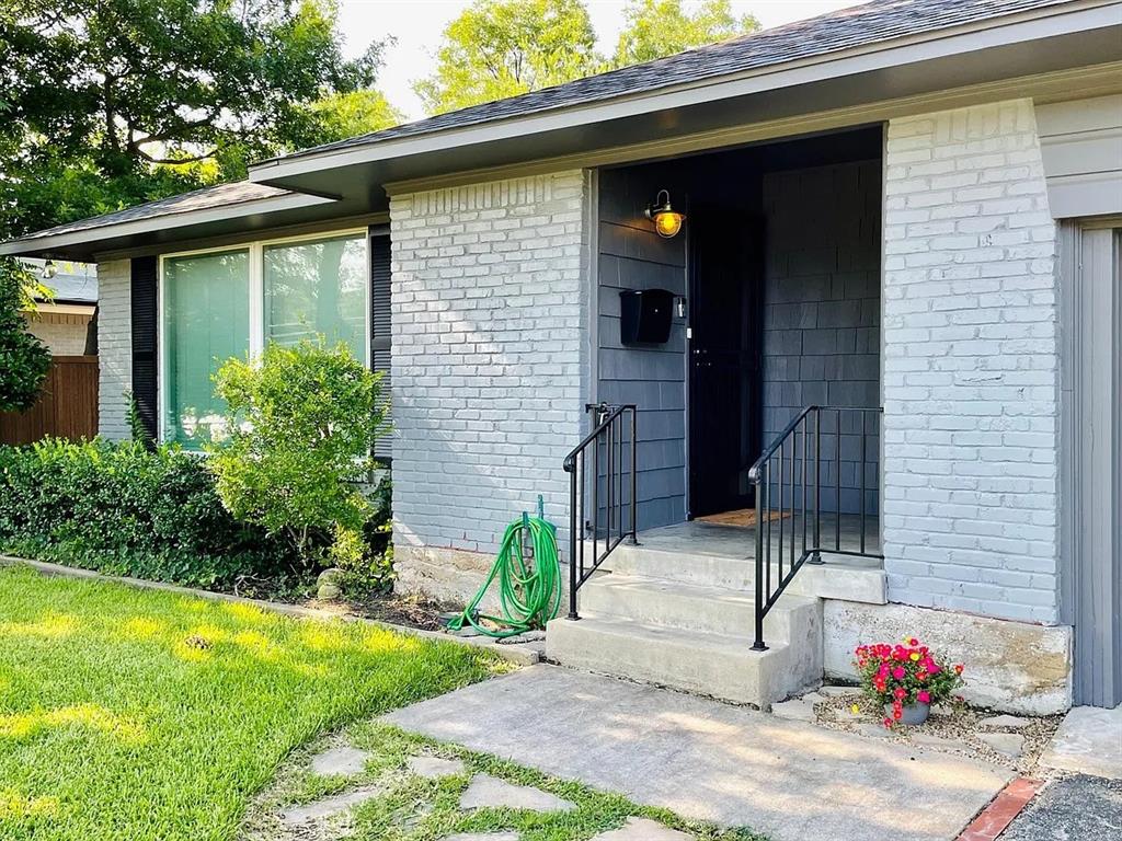 3152 Walnut Hill Lane Dallas, TX 75229 - Photo 2 of 18 a front view of a house with a yard