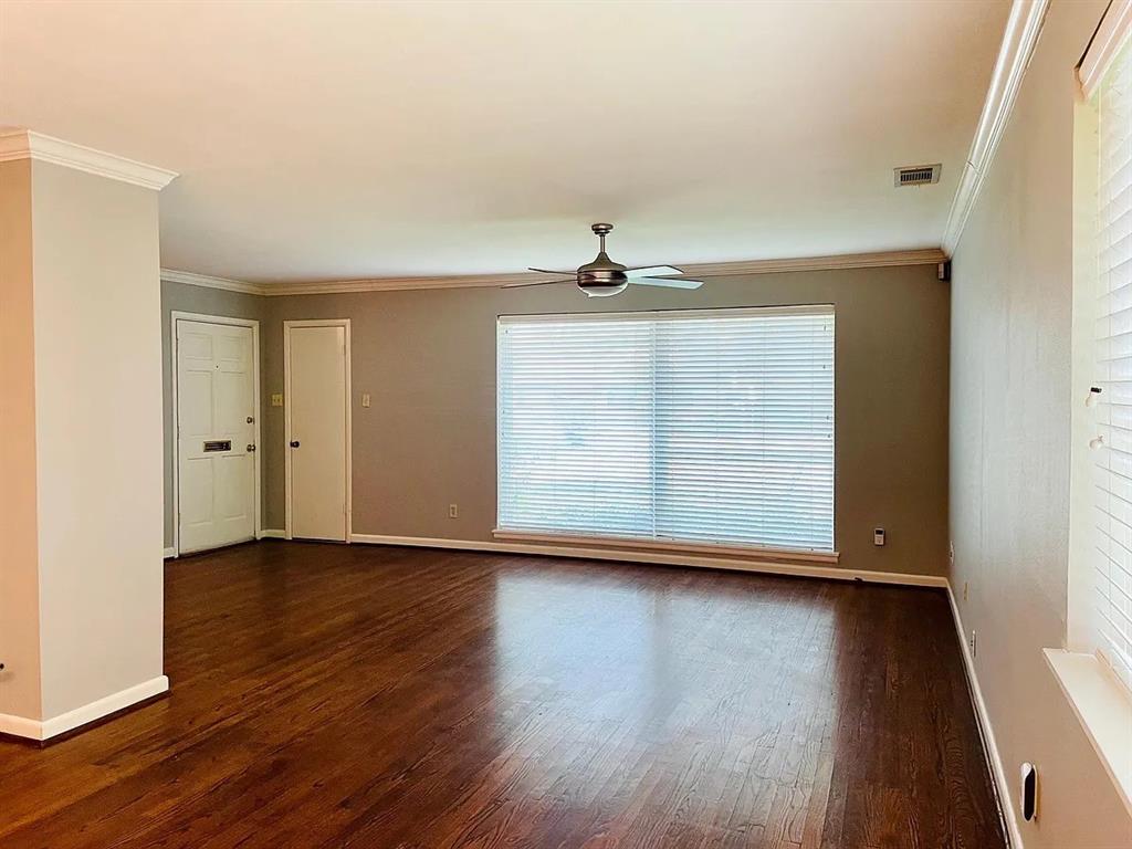 3152 Walnut Hill Lane Dallas, TX 75229 - Photo 9 of 18 a view of an empty room with wooden floor and a window