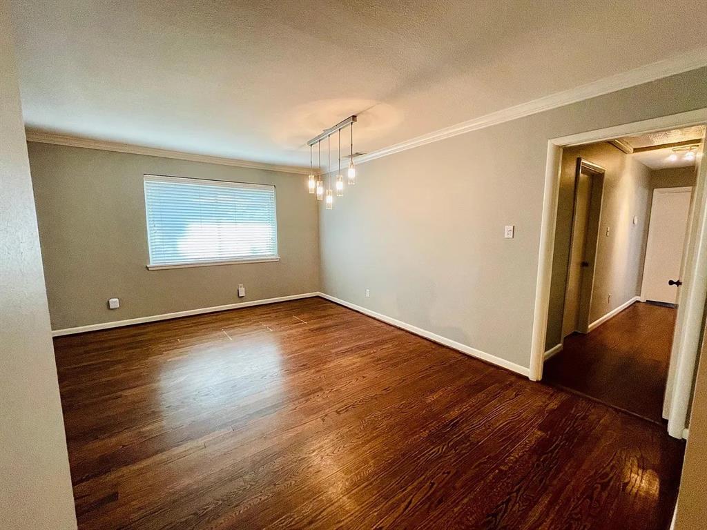 3152 Walnut Hill Lane Dallas, TX 75229 - Photo 10 of 18 an empty room with wooden floor and windows