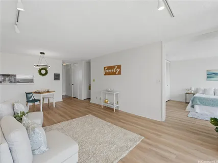 a living room with furniture and a wooden floor