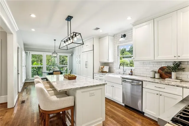 a kitchen with a sink stove and cabinets
