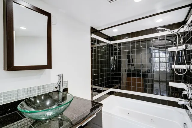 a bathroom with a tub and a sink