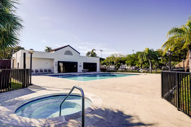 a view of a house with swimming pool and sitting area