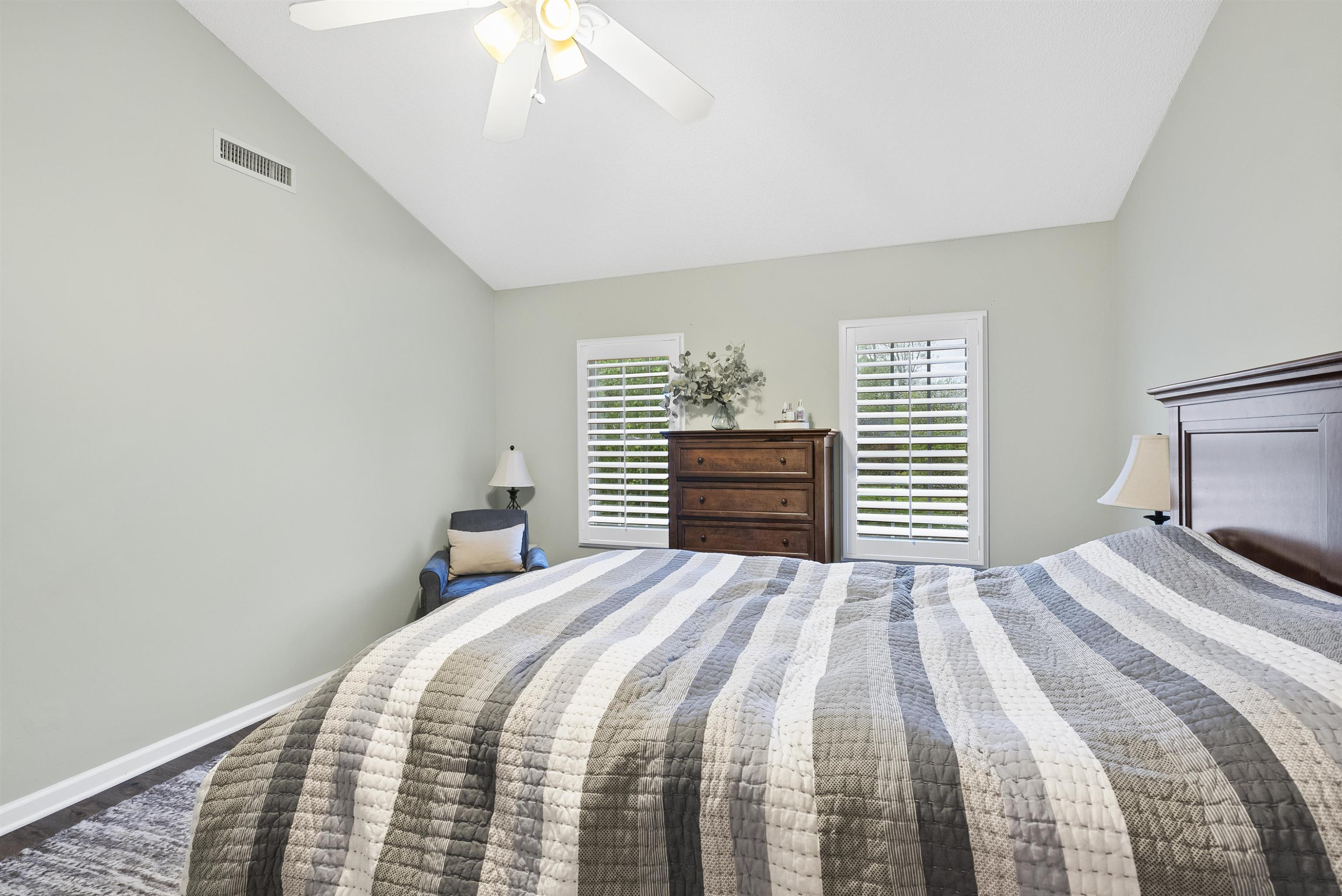 408 Chancellors Ridge Drive Durham, NC 27713 - Photo 24 of 34 a bedroom with a bed and a chandelier